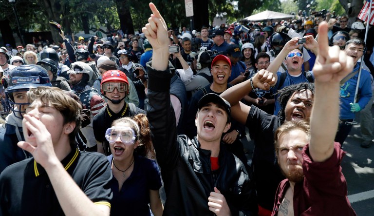 In this Thursday, April 27, 2017 file photo, demonstrators shout slogans directed at city hall during a rally for free speech near the University of California, Berkeley campus in Berkeley, Calif. Since the beginning of 2016, more than two dozen campus speeches have been derailed amid controversy, according to the Foundation For Individual Rights In Education, a group that monitors free speech on campuses.