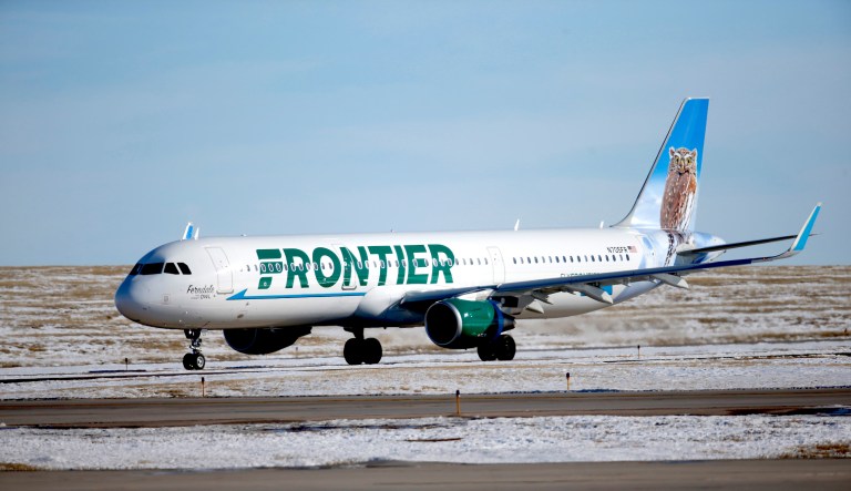 In this photograph taken late Monday, Feb. 8, 2016, a Frontier Airlines plane heads to a runway at Denver International Airport.