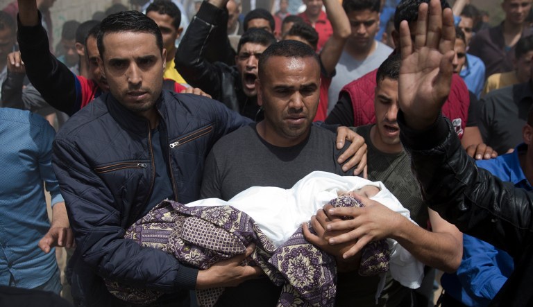 Mourners carry the body of a Palestinian, 14-month-old, Seba Abu Arar, during her funeral in Gaza City, Sunday, May. 5, 2019. Gaza's Health Ministry said the infant was killed when Israeli aircraft hit near their house. Abu Arar, died immediately Saturday and her pregnant relative died later, the ministry added. Another child was moderately injured. An Israeli military spokesman said Sunday that a detailed review found that a Palestinian rocket had misfired and killed them.