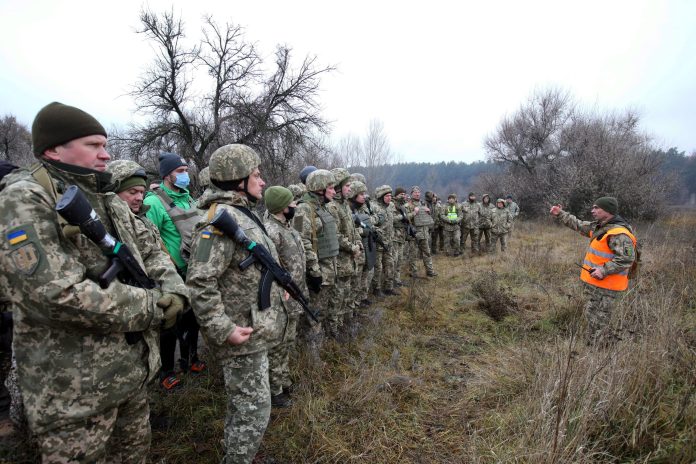 KHARKIV REGION, UKRAINE -  DECEMBER 11, 2021 - Men in camouflage uniforms line up during the drills of the Territorial Defence units in Kharkiv Region, northeastern Ukraine.