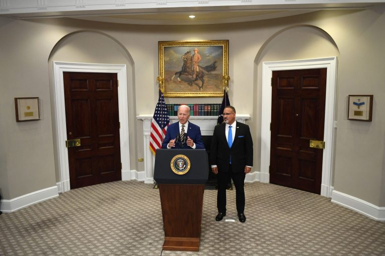 President Joe Biden announces student loan relief with Education Secretary Miguel Cardona on August 24 in the Roosevelt Room of the White House.