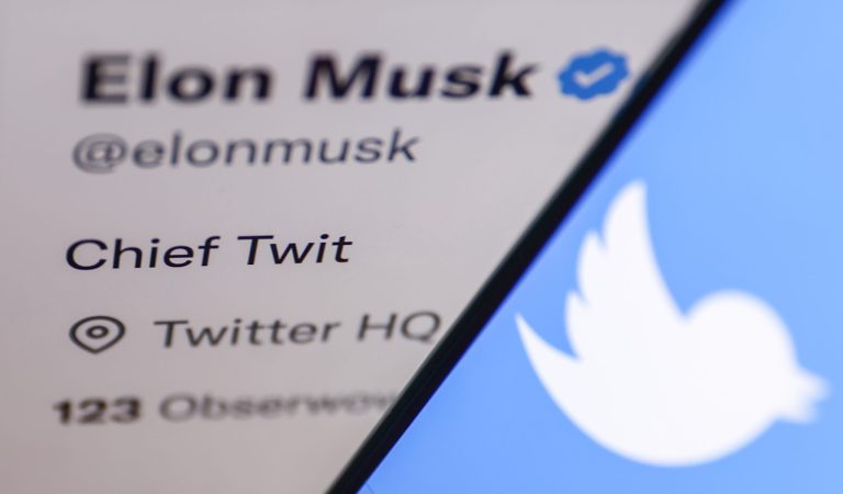 Twitter logo displayed on a phone screen and Elon Musk's Twitter account displayed on a screen are seen in this illustration photo taken in Krakow, Poland, on Oct. 30, 2022. 