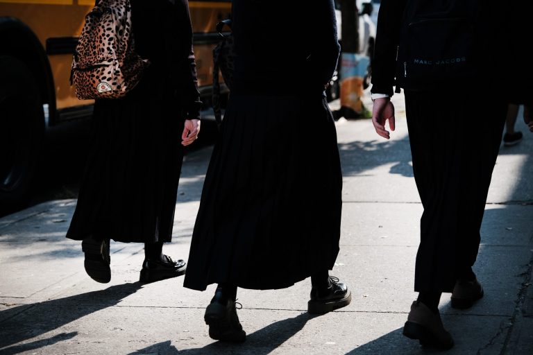 Orthodox Jewish children walk down a street outside of a yeshiva school in Borough Park on Sept.12 in the Brooklyn borough of New York City.