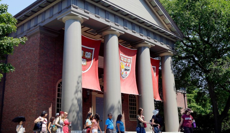 FILE - In this Aug. 30, 2012, file photo, a tour group walks through the campus of Harvard University in Cambridge, Mass. Word of an August 2017 Justice Department inquiry into how race factors into admissions at Harvard University has left top-tier colleges bracing for scrutiny of practices that have boosted diversity levels to new highs. While they keep their selection formulas under wraps, Ivy League colleges defend race-conscious approaches that contributed to a 17 percent increase in nonwhite students over a recent five-year span.