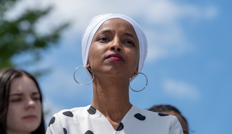 Rep. Ilhan Omar, D-Minn., listens as she joins Democratic presidential candidate, Sen. Bernie Sanders, I-Vt., to call for legislation to cancel all student debt, at the Capitol in Washington, Monday, June 24, 2019.