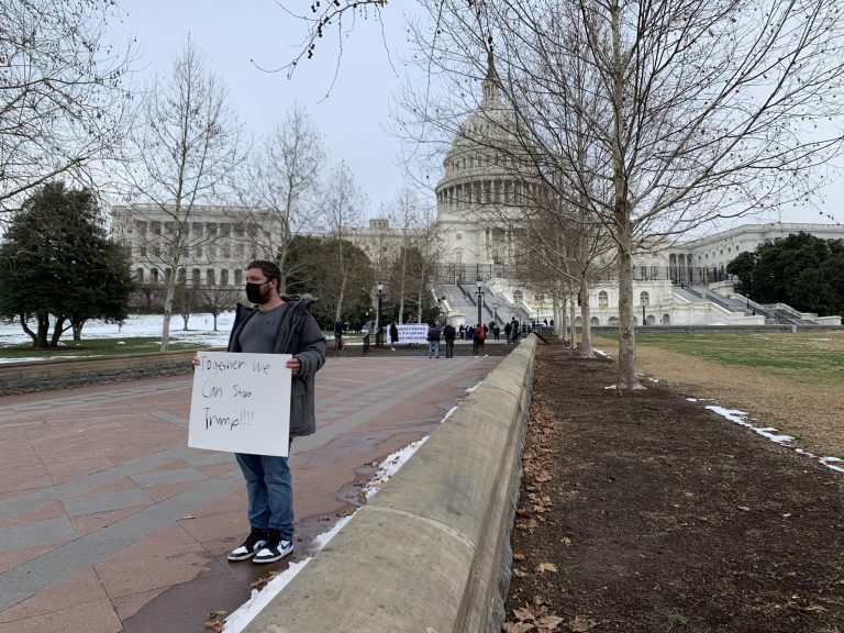 A lone anti-Trump protester on the west side of the Capitol on the first anniversary of the January 6th riots