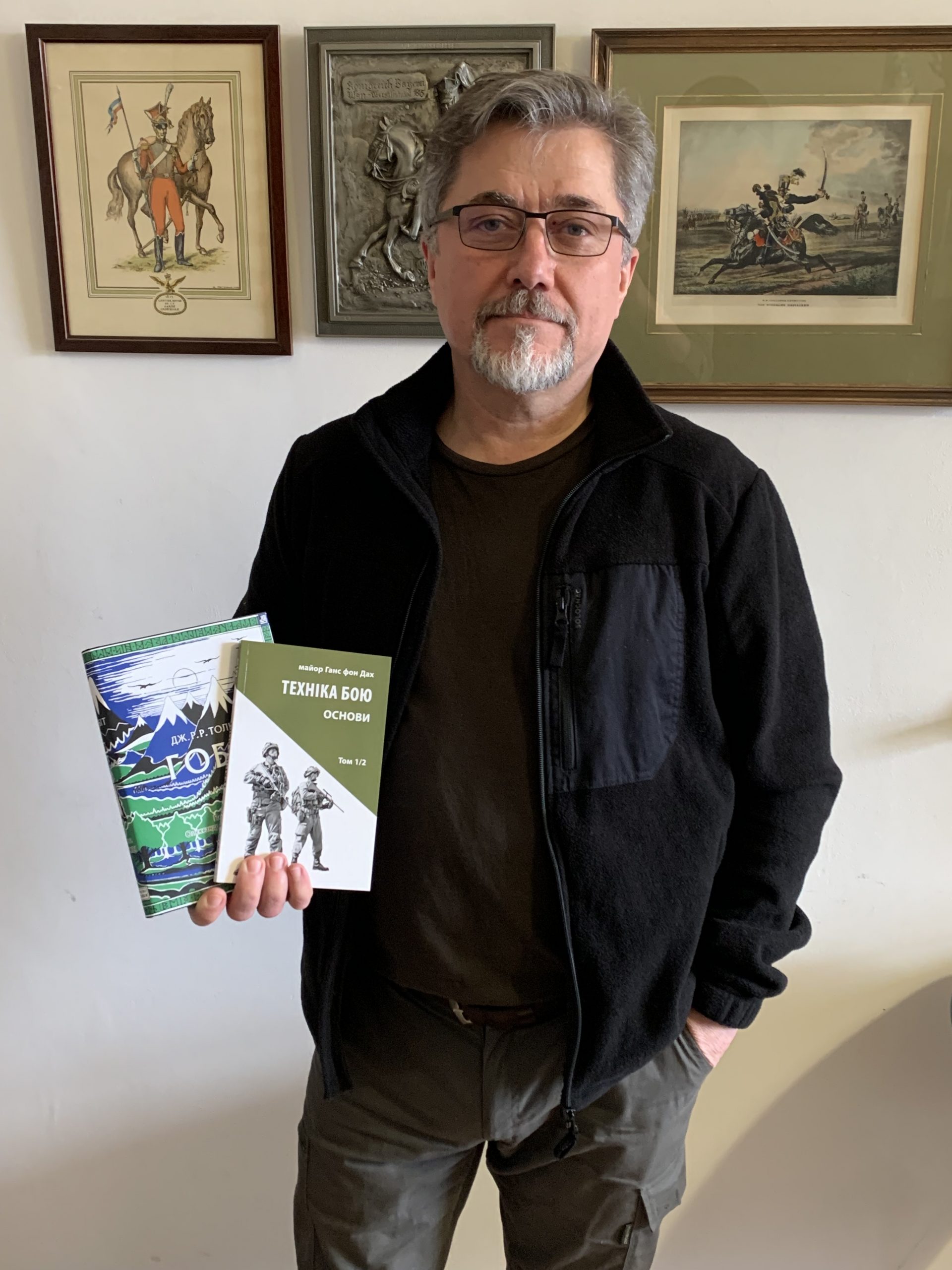 Astrolabe Publishing founder Oleh Feschowetz holds two books sold by his company, including a translation of J.R.R. Tolkien's "The Hobbit" (left).