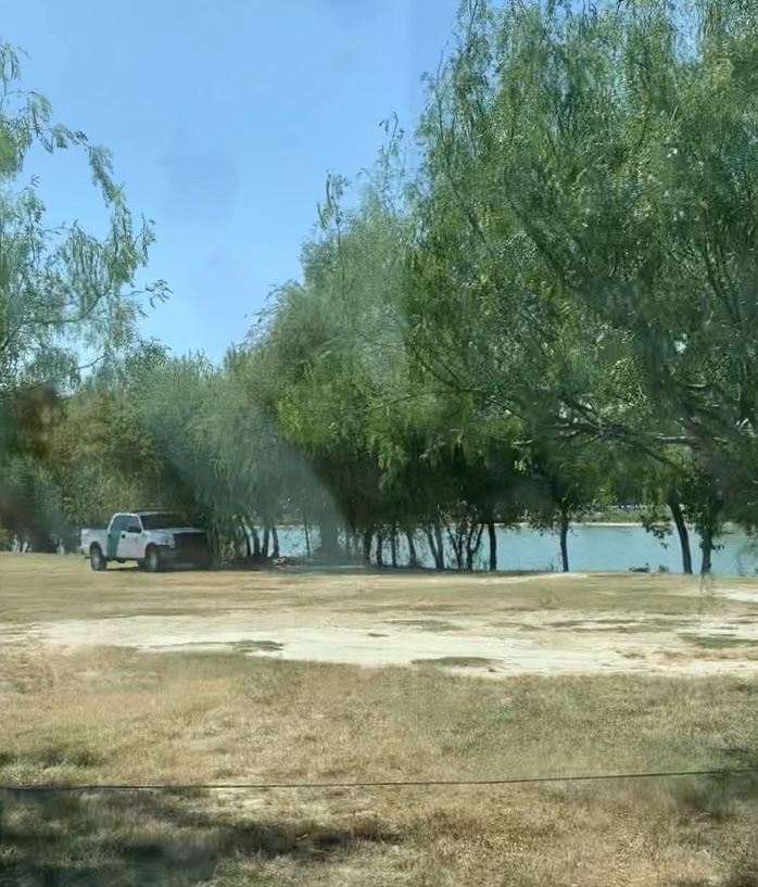 A Border Patrol agent sits on the shore of the Rio Grande River near Anzalduas Park.