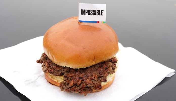FILE- This Jan. 11, 2019, file photo shows the Impossible Burger, a plant-based burger containing wheat protein, coconut oil and potato protein among it's ingredients in Bellevue, Neb. From soy-based sliders to ground lentil sausages, plant-based meat substitutes are surging in popularity. 