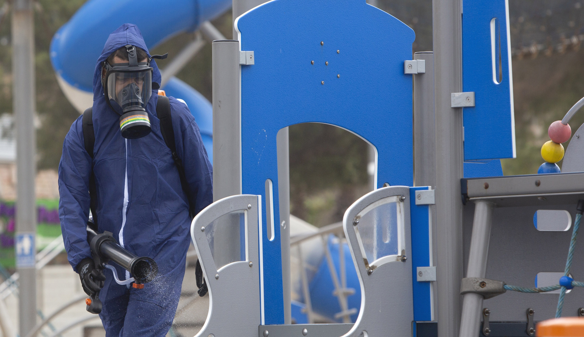 A worker sprays disinfectant as a precaution against the coronavirus in a playground in the central Israeli city of Bat Yam on Wednesday.