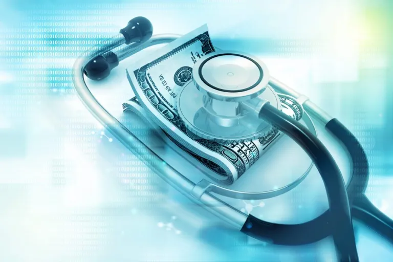 A stethoscope with money under it.