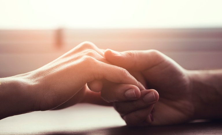 A couple holding hands.
