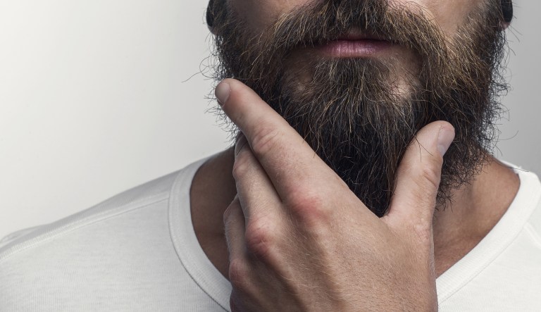 Man touching his beard.