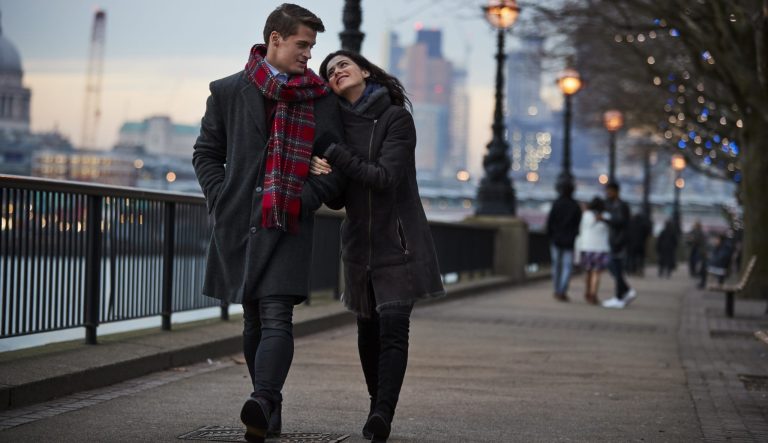 A couple walking, lovingly.