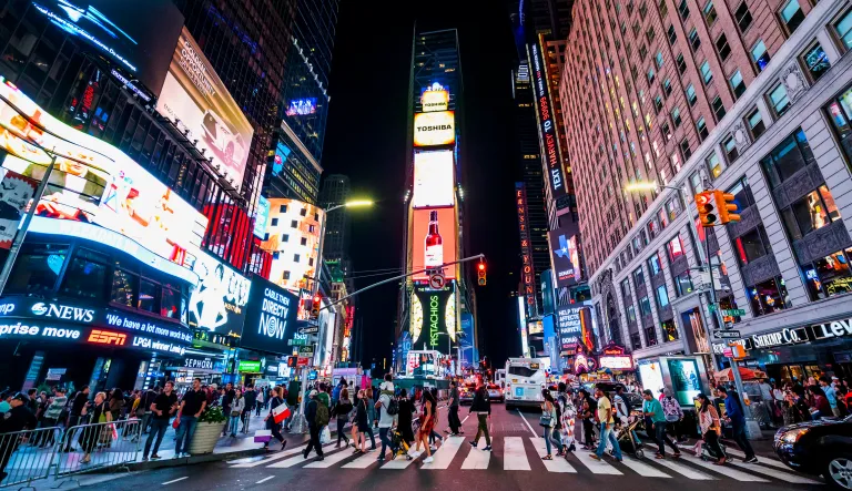 Crowds walk through Times Square in New York City.
