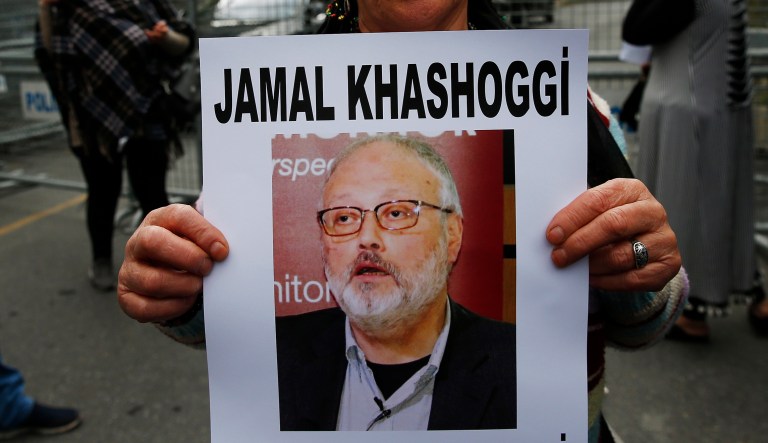 An activist, member of the Human Rights Association Istanbul branch, holds a poster with a photo of missing Saudi journalist Jamal Khashoggi, during a protest in his support near the Saudi Arabia consulate in Istanbul, Tuesday, Oct. 9, 2018. Turkey said Tuesday it will search the Saudi Consulate in Istanbul as part of an investigation into the disappearance of a missing Saudi contributor to The Washington Post, a week after he vanished during a visit there. 