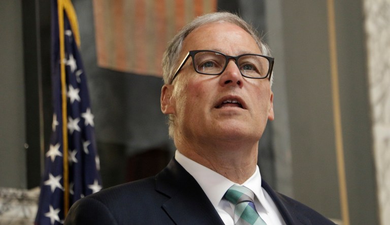 Washington Gov. Jay Inslee speaks before signing a measure that puts the state on track to create the first 'public option' health insurance in the US, Monday, May 13, 2019, in Olympia, Wash. The new law is a hybrid system that will see private insurers offer state-defined plans.