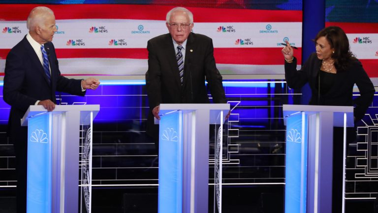 Democratic presidential candidate former Vice-President Joe Biden, left, and Sen. Kamala Harris, D-Calif., spar during the Democratic primary debate hosted by NBC News at the Adrienne Arsht Center for the Performing Arts, Thursday, June 27, 2019, in Miami. Sen. Bernie Sanders, I-Vt., is in the center. 