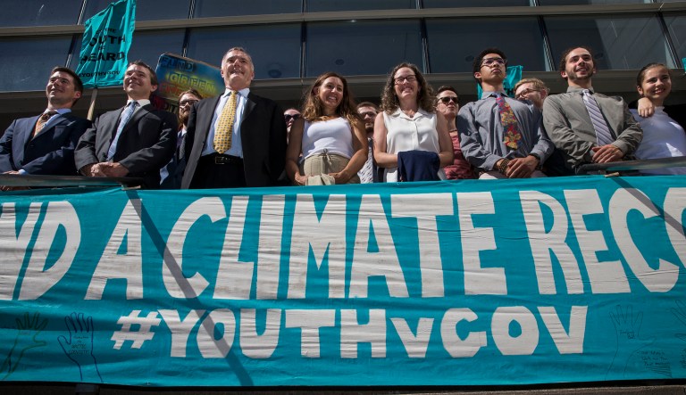 Lawyers and the youth plaintiffs lineup behind a banner after a hearing before Federal District Court Judge Ann Aiken between lawyers for the Trump Administration and the so called Climate Kids in Federal Court in Eugene, Ore. Wednesday July 18, 2018. The Trump administration has gone to the U.S. Supreme Court in its effort to stop a lawsuit filed by young activists who say the government is failing to protect them from climate change.