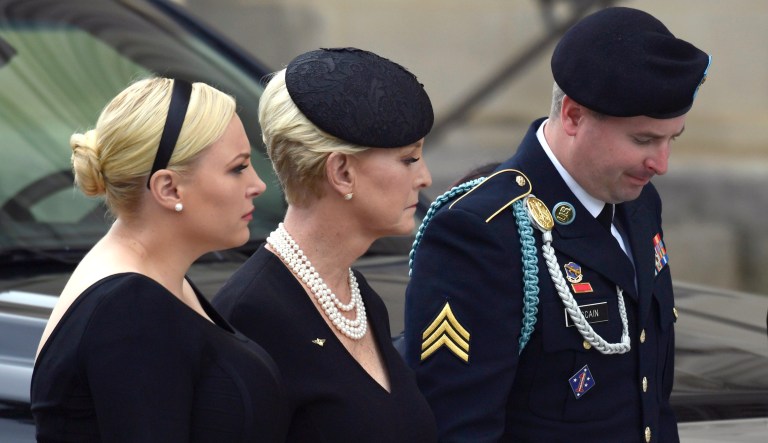 Cindy McCain, center, flanked by her children Meghan McCain, left, and James McCain, right, watch as the casket of Sen. John McCain, R-Ariz., arrives at the Washington National Cathedral in Washington, Saturday, Sept. 1, 2018, for a memorial service. McCain died Aug. 25 from brain cancer at age 81.