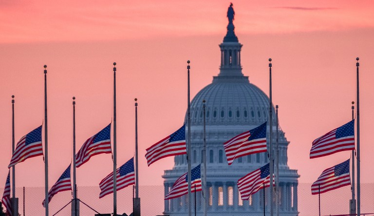 Flags flying a half-staff in honor of Sen. John McCain, R-Ariz., frame the U.S. Capital at daybreak in Washington, Sunday, Aug. 26, 2018. McCain, 81, died at his ranch in Arizona after a yearlong battle with brain cancer.