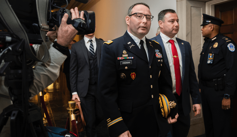 National Security Council aide Lt. Col. Alexander Vindman, left, leaves Capitol Hill as they conclude a public impeachment hearing of President Donald Trump's efforts to tie U.S. aid for Ukraine to investigations of his political opponents, in Washington, Tuesday, Nov. 19, 2019. (AP Photo/Manuel Balce Ceneta)