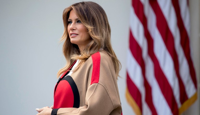 First lady Melania Trump waves to children and others as she visits Chipala Primary School, in Lilongwe, Malawi, on Thursday. Mrs. Trump is visiting Africa on her first big solo international trip, aiming to make child well-being the focus of a five-day, four-country tour. 