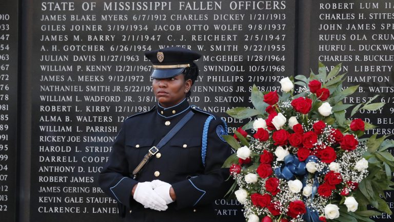 Jackson Police Department investigator Stephanie Horn stands at attention as she protects the wreath posted along the wall of Mississippi Fallen Officers, at the 9th annual Law Enforcement Memorial Candlelight Vigil at the State Capitol Mall, in Jackson, Miss., where fallen lawmen from throughout the state are honored for their dedication and service, Wednesday, May 15, 2019. The service was one of many nationwide during Peace Officers Memorial Day. 
