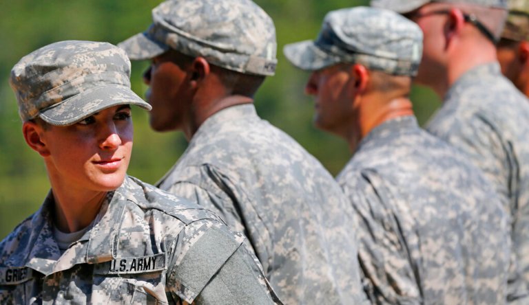 U.S. Army Capt. Kristen Griest, left, of Orange, Conn., stands in formation during an Army Ranger School graduation ceremony on at Fort Benning, Ga. 