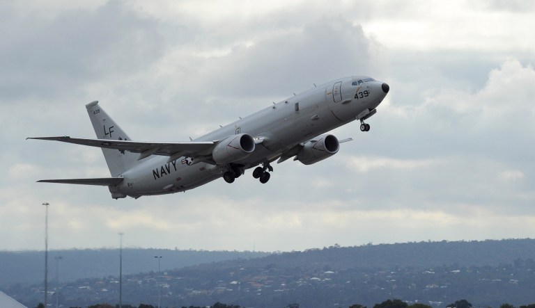 A U.S. Navy P-8 Poseidon aircraft flies out from Perth, Australia, International Airport Wednesday, April 16, 2014.