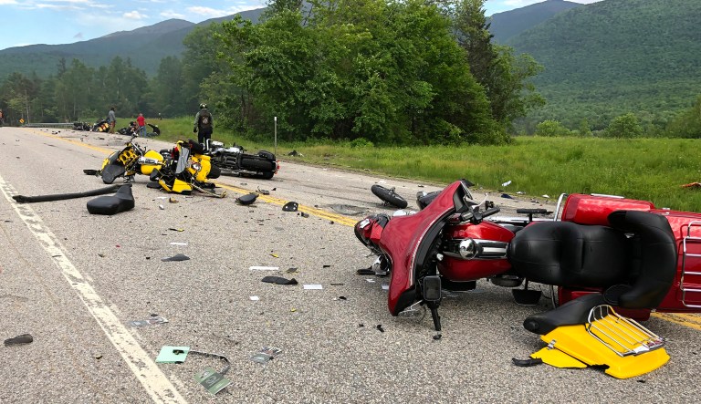 This photo provided by Miranda Thompson shows the scene where several motorcycles and a pickup truck collided on a rural, two-lane highway Friday, June 21, 2019 in Randolph, N.H. 