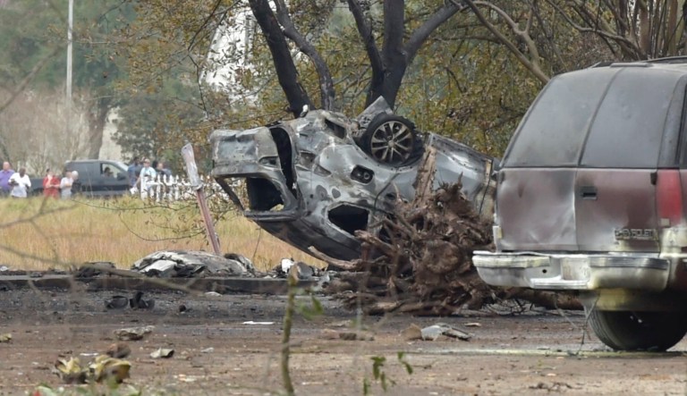 A view of a damaged vehicle near the site of a plane crash near Feu Follet Road and Verot School Road in Lafayette, La., Saturday, Dec. 28, 2019.  Authorities confirmed the accident but details on whether anyone was injured was not immediately known.