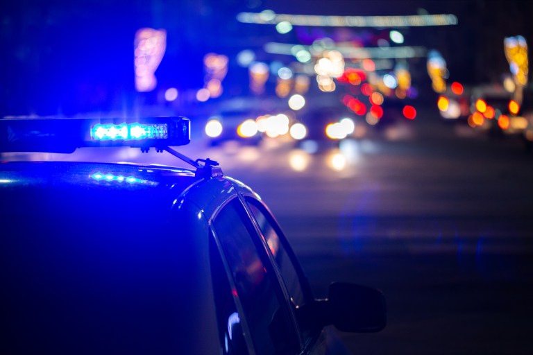 A police car drives with its lights flashing in Philadelphia, Tuesday, Jan. 8, 2019.