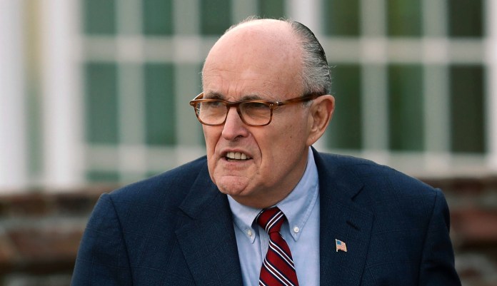 FILE - In this Nov. 20, 2016 file photo, former New York Mayor Rudy Giuliani arrives at the Trump National Golf Club Bedminster clubhouse in Bedminster, N.J. President Donald Trump's new lawyer Rudy Giuliani said Wednesday, May 2, 2018, the president repaid attorney Michael Cohen for a $130,000 payment to porn star Stormy Daniels. Giuliani made the revelation during an appearance on Fox News Channel's "Hannity."