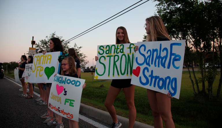 Hannah Cook, 16, second from right, of Kingwood, Texas, drove down to stand in front of Santa Fe High School with her fellow high school dance teammates to show support for the students returning to class today for the first time since a 17-year-old boy shot and killed ten people on campus and injured 13.