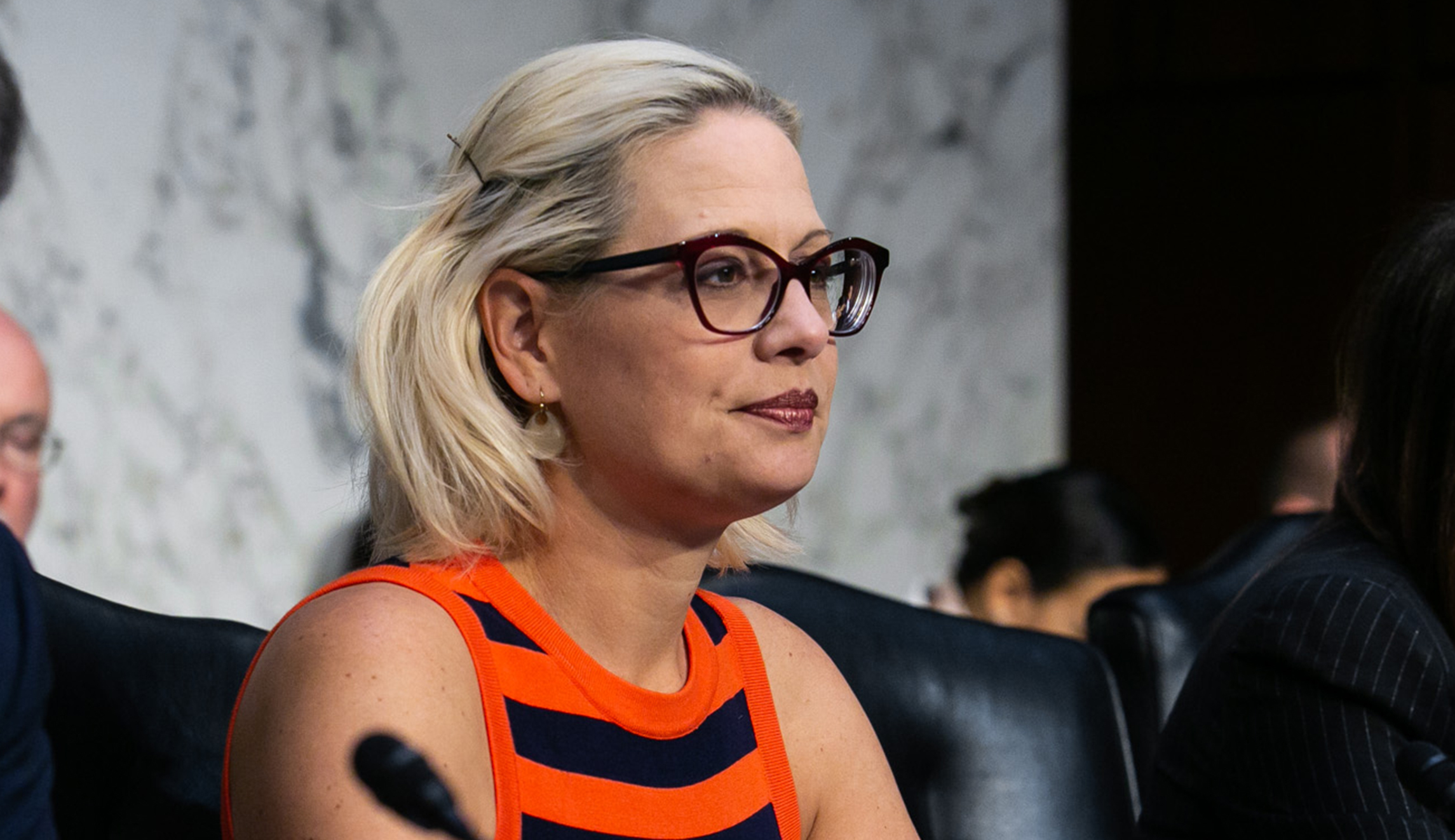 The mob comes for Kyrsten Sinema