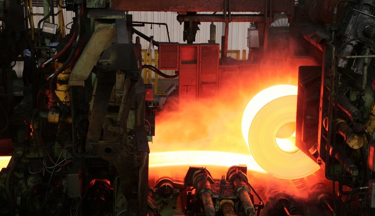 Red hot steel is rolled into coils at a steel factory in Brazil.