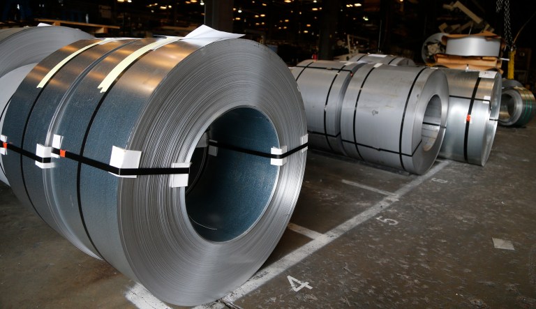 In this Wednesday, July 11, 2018, photo rolls of steel sit in a warehouse at a fabrication company in Chester, Va.