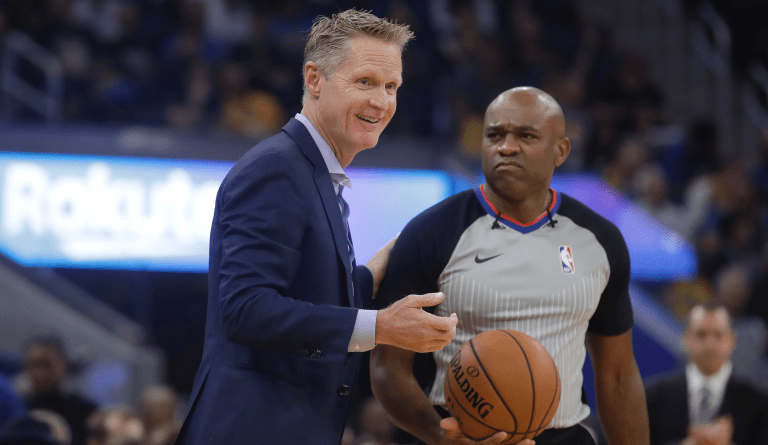 Golden State Warriors head coach Steve Kerr smiles while talking to an official during the first half of a preseason NBA basketball game between the Warriors and the Los Angeles Lakers in San Francisco, Saturday, Oct. 5, 2019. (AP Photo/Jeff Chiu)