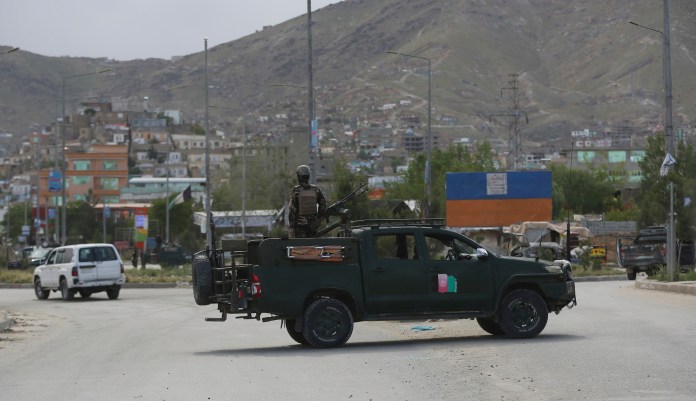 Afghan security forces inspect the site of a bomb explosion in Kabul, Afghanistan, Monday, May 18, 2020. A suicide bomber in a stolen military Humvee targeted a base in eastern Afghanistan belonging to the country's intelligence service early on Monday, killing at least nine members of the force, Afghan officials said. The Taliban claimed responsibility for the attack.