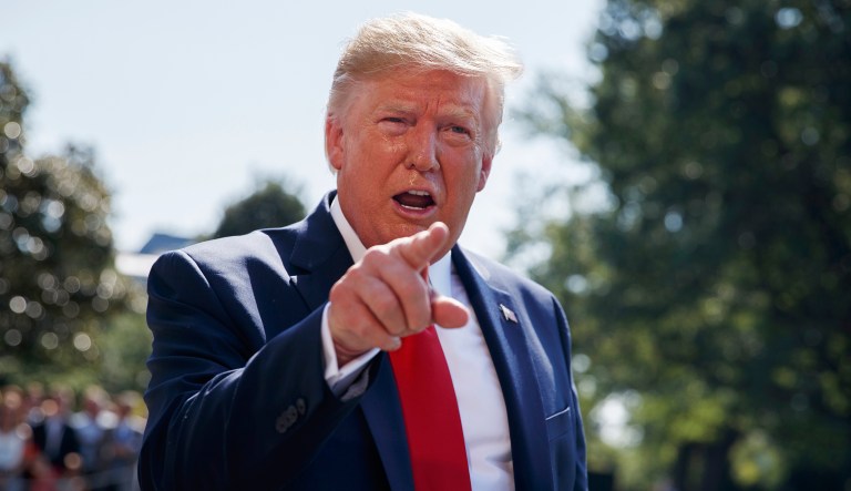 President Donald Trump talks to reporters on the South Lawn of the White House in Washington.