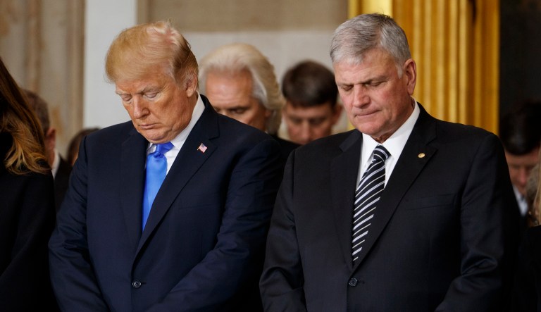 President Donald Trump and Franklin Graham pray during a ceremony honoring Reverend Billy Graham in the Rotunda of the U.S. Capitol building, Wednesday, Feb. 28, 2018, in Washington.