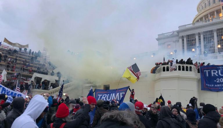Police begin clearing angry protesters from the Capitol building in Washington by using tear gas on Wednesday, Jan. 6, 2021. Demonstrators responded by taunting and yelling at law enforcement before retreating from the toxic gas and the officers with riot shields. 
