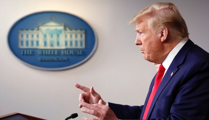President Donald Trump arrives to speak about the coronavirus in the James Brady Press Briefing Room of the White House, Tuesday, March 31, 2020, in Washington's Dr. Anthony Fauci, director of the National Institute of Allergy and Infectious Diseases, watches. 