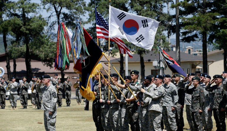 Soldiers from the U.S. Army's 2nd Infantry Division and South Korean Army salute during the Combined Division activation ceremony at Camp Red Cloud in Uijeongbu, South Korea, Wednesday, June 3, 2015. This combined division will consist of the U.S. Army's 2nd Infantry Division and a brigade of South Korea Army.