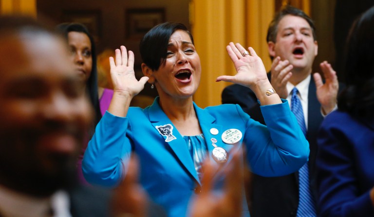 Virginia Virginia House of Delegate member, Del. Hala Ayala, D-Prince William County, center, reacts to the remarks of Virginia House of Delegates, Speaker Eileen Filler-Corn, D-Fairfax, during opening ceremonies of the 2020 Virginia General Assembly at the Capitol in Richmond, Va., Wednesday, Jan. 8, 2020. 