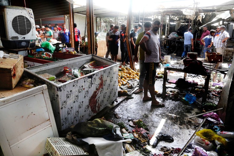 A bomb at an outdoor market in a Shiite-dominated Baghdad neighborhood on Tuesday killed more than 30 people and wounded dozens, a police official said. (AP Photo/Khalid Mohammed)