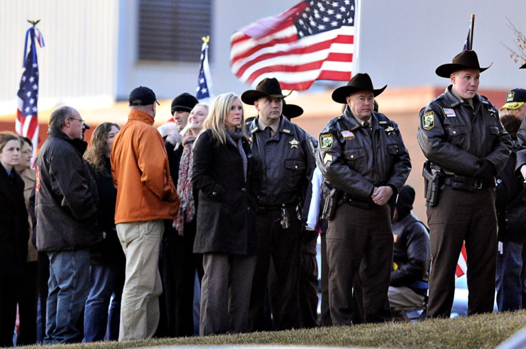   People were lined along the front of St. Boniface Catholic Church in Cold Spring, Minn., to pay their respects during a visitation for Cold Spring-Richmond Police Officer Tom Decker, Tuesday, Nov. 4, 2012. The investigation into the killing of Decker in Cold Spring continues, and authorities were still looking for the 20-gauge shotgun that is believed to be the murder weapon, officials said. (AP Photo/St. Cloud Times, Jason Wachter)  