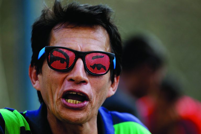 A supporter of Venezuela's President Hugo Chavez wears sunglasses decorated with the eyes of Venezuela's President Hugo Chavez at a rally in Caracas, Venezuela, Wednesday, Jan. 23, 2013. The cult of personality that Chavez long nurtured has been flourishing like never before as he confronts an increasingly difficult struggle against the mysterious cancer that afflicts him. The iconic eyes-only design sends a message that he is always watching and still with his adoring constituents. (AP Photo/Fernando Llano)