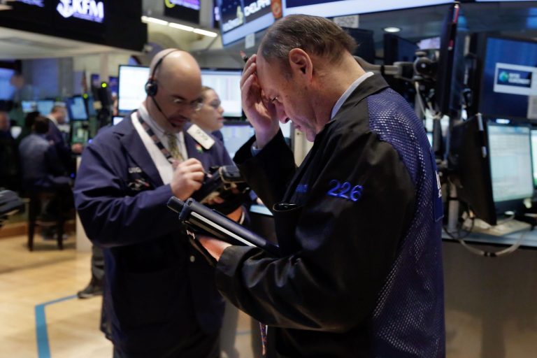 Trader Randy Beller, right,  works on the floor of the New York Stock Exchange, Monday, April 7, 2014.  Stocks are starting out the week the same way they ended the last one,  down. (AP Photo/Richard Drew)